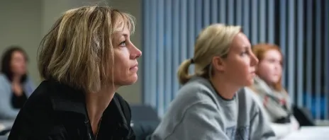 A student looking forward attentively in a classroom.